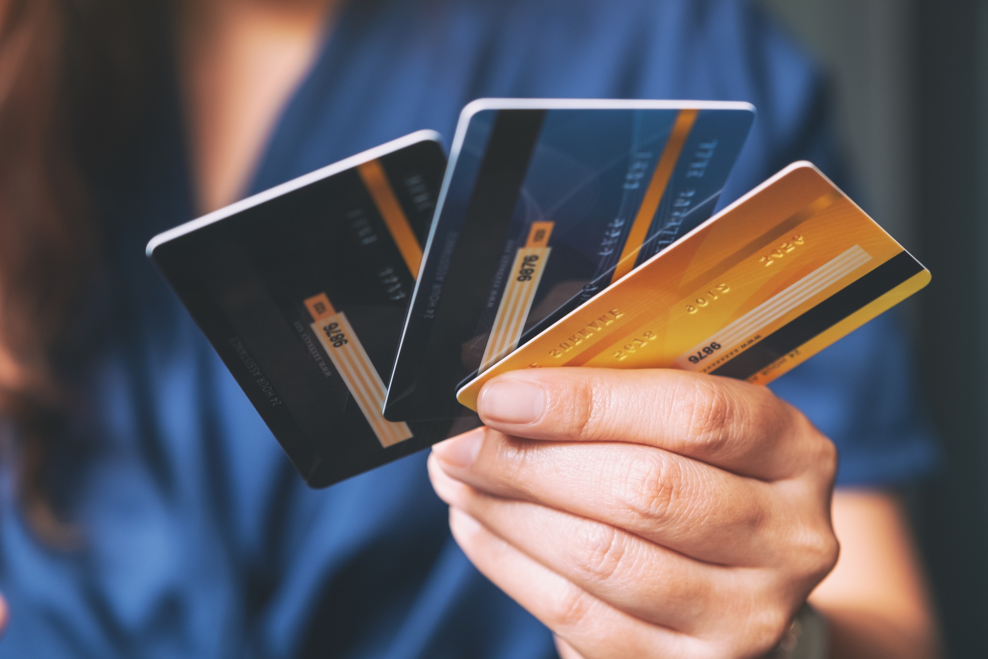 Closeup image of a woman holding and showing credit cards